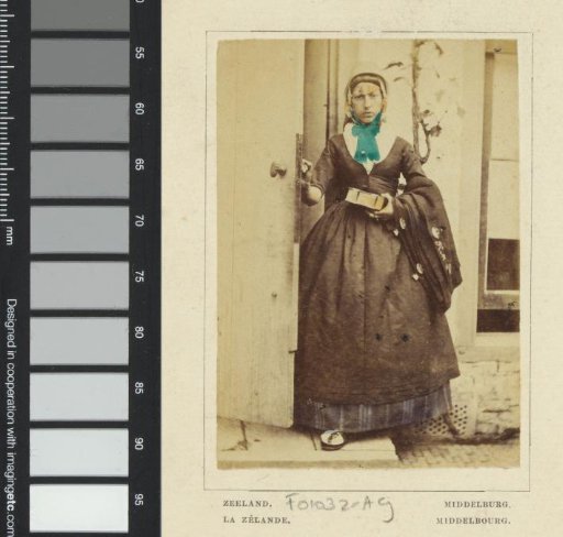 Portrait of an Unknown Woman with Photo Album or Book in Traditional Dress from Middelburg, Zeeland