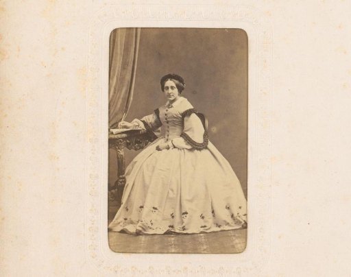 Portrait of a writing woman, seated at a table