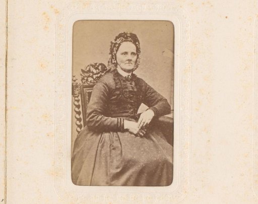 Portrait of a seated woman with a cap