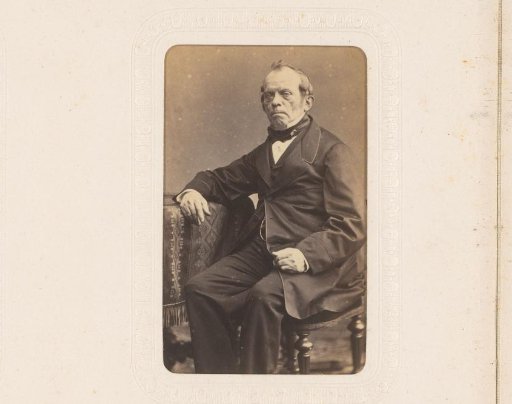 Portrait of a seated man, leaning on a table