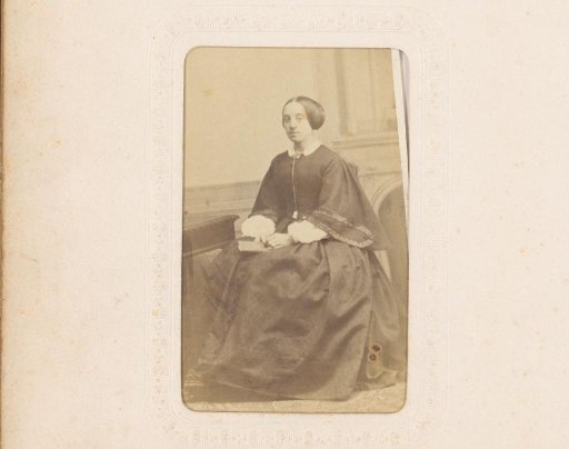 Portrait of a seated woman with a book in her hand