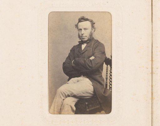 Portrait of a seated man with sideburns