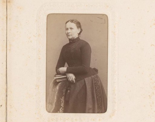 Portrait of Jeane Meyer Leaning on a Stack of Books on the Back of a Chair