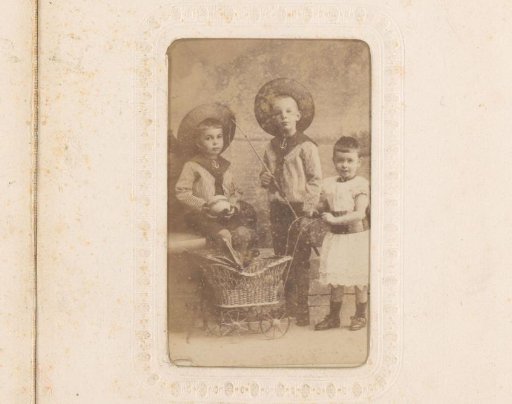 Portrait of two boys with hats and a girl with a toy pram