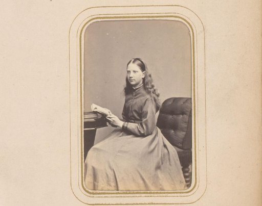 Portrait of a Girl with Open Book in Hand, Seated at a Table