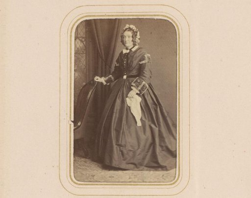 Portrait of a Woman with Cap in Hand, Standing by a Chair
