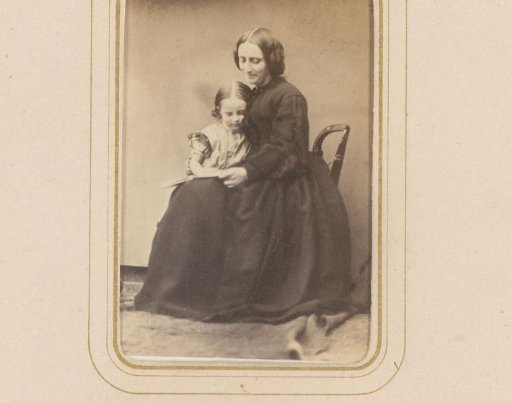 Portrait of a seated woman with a girl on her lap