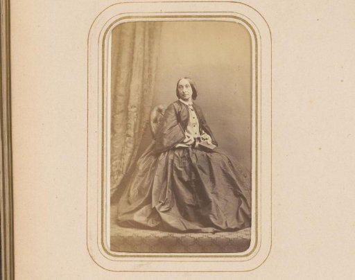 Portrait of a seated woman with a book in her hand