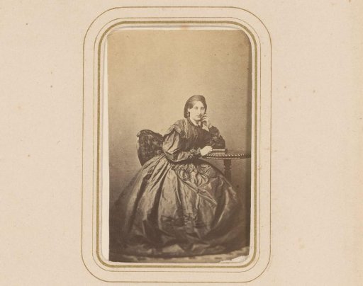 Portrait of a woman, seated at a table