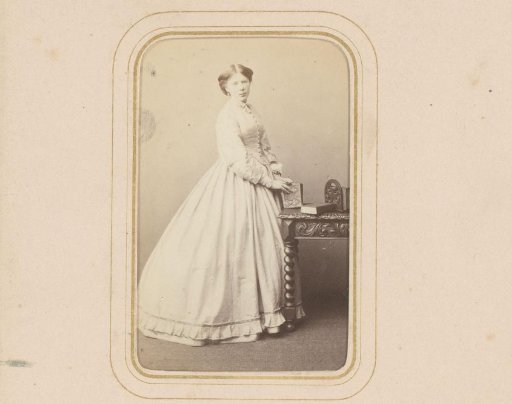 Portrait of a Young Woman Standing by a Table with Books