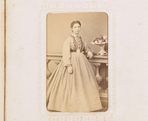 Portrait of a woman, standing by a balustrade