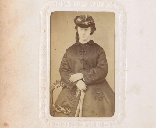 Portrait of a standing woman with a cloak and hat