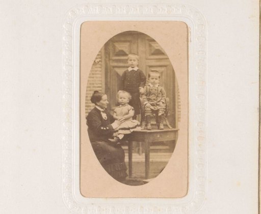Portrait of a woman and three children, the children standing and seated on a table
