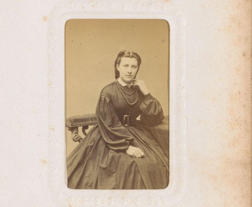 Portrait of a seated young woman with necklaces