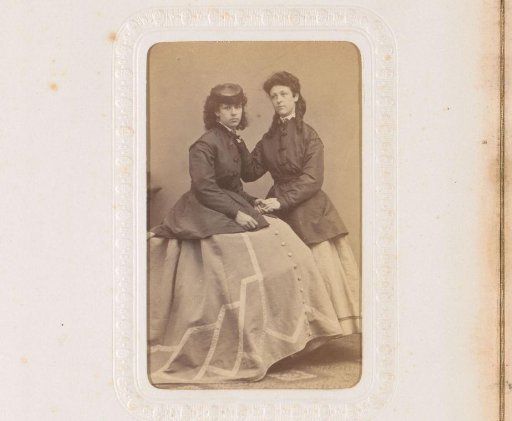 Portrait of two young women, one wearing a hat