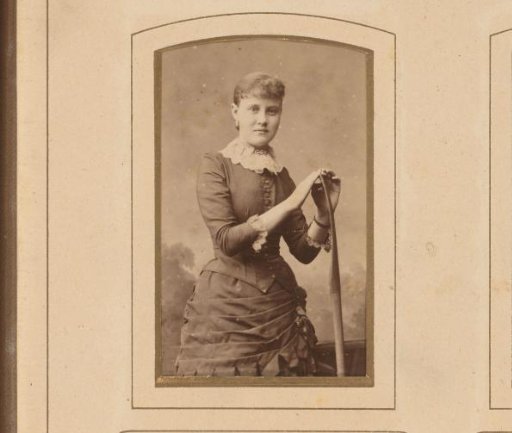 Portrait of a standing woman with an oar