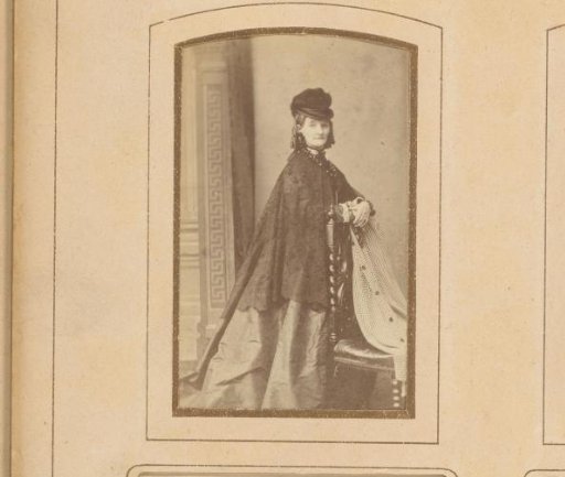 Portrait of a Woman with a Cape and Hat, Standing Beside a Chair