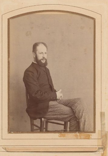 Portrait of a seated man with a moustache and beard