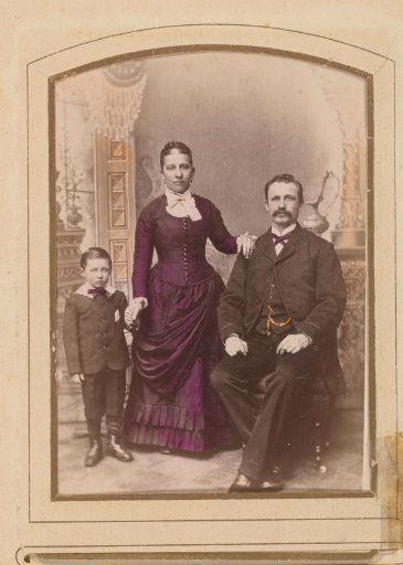 Portrait of a standing woman, a seated man and a boy