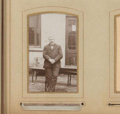Portrait of a Man Leaning on a Table in a Courtyard