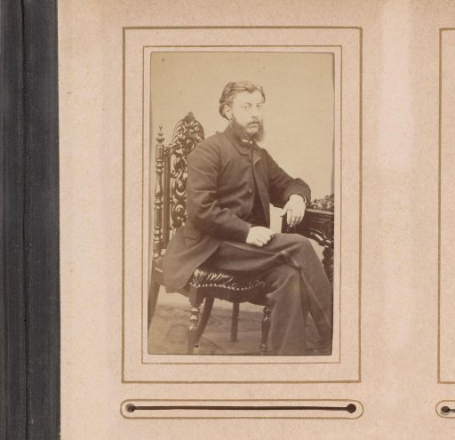 Portrait of a seated man with a beard