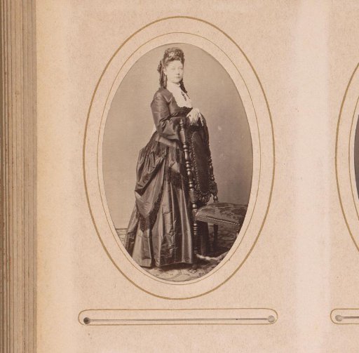 Portrait of a woman standing by a chair