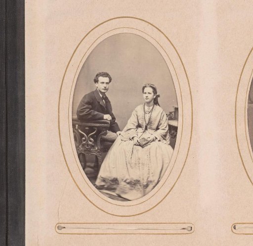 Portrait of a man and woman, seated with a book