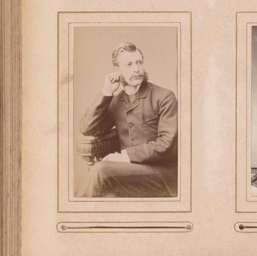 Portrait of a seated man with sideburns