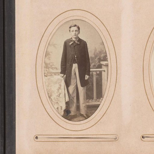 Portrait of a boy, standing by a table