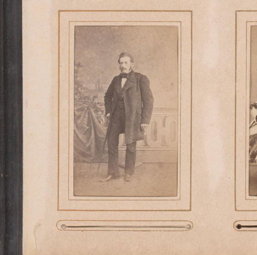 Portrait of a standing man with a walking stick