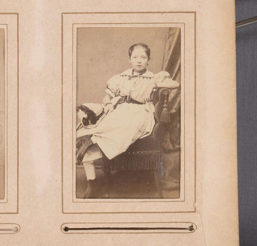 Portrait of a girl, seated on a chair