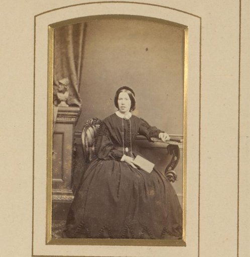 Portrait of a seated woman holding a book