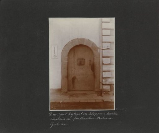 Closed door between the town hall and the post office in Batavia, left a sign of the ANIW