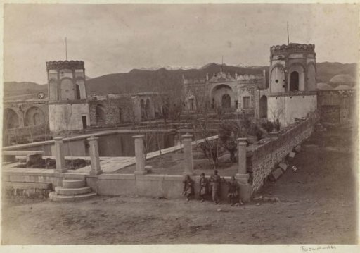 Walled courtyard in Persia with a pond, towers, and children in the foreground