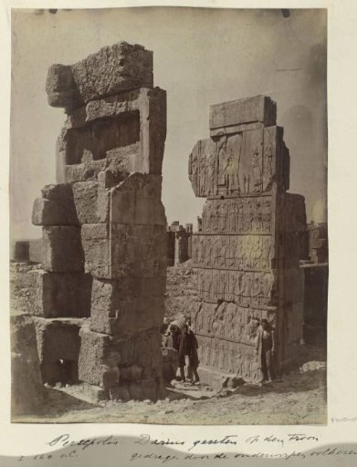 Three men posing at a relief at an entrance of the Hall of a Hundred Columns in Persepolis