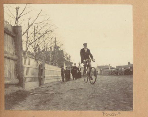 Joseph Cheetham on a bicycle in a village street in Russia