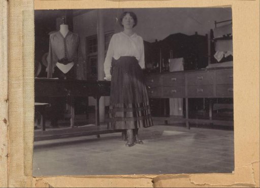 European woman posing next to a mannequin, probably in Yogyakarta