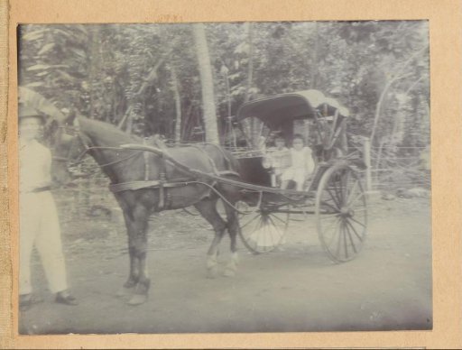 Children and a man with a carriage, probably on Java