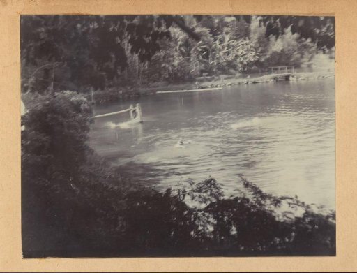 View of a river with swimmers in the Dutch East Indies