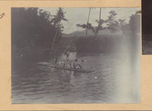Boys on a raft at Kali Taman in the Dutch East Indies