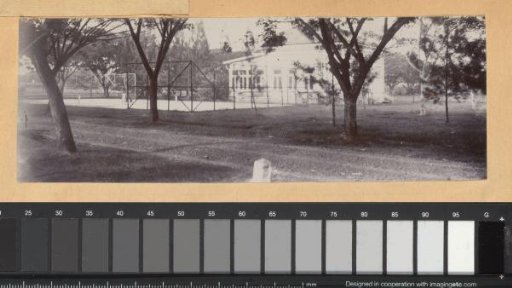View of a house with a tennis court in the Dutch East Indies