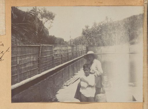 Woman and boy by a swimming pool in Yogyakarta