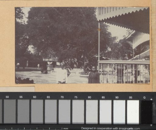 Two people standing by a veranda, probably in Yogyakarta