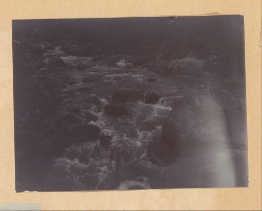 Woman sitting in a stream, presumably Kali Taman in Salatiga