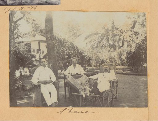 European men and a woman with a dog in a garden in Surabaya