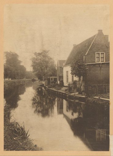 View of houses along a canal with advertisement for Bensdorp cocoa on the right in the Netherlands
