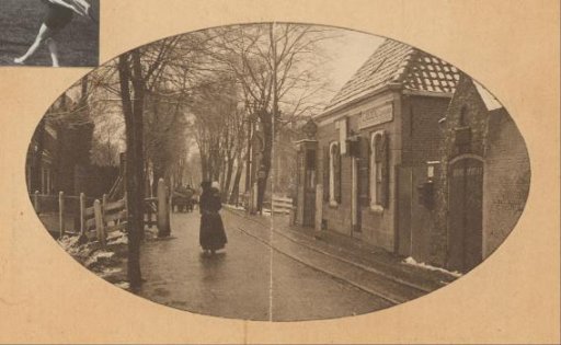 Village street with passers-by and a stable in the Netherlands
