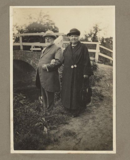Portrait of an older man and woman by a bridge, probably in the Netherlands