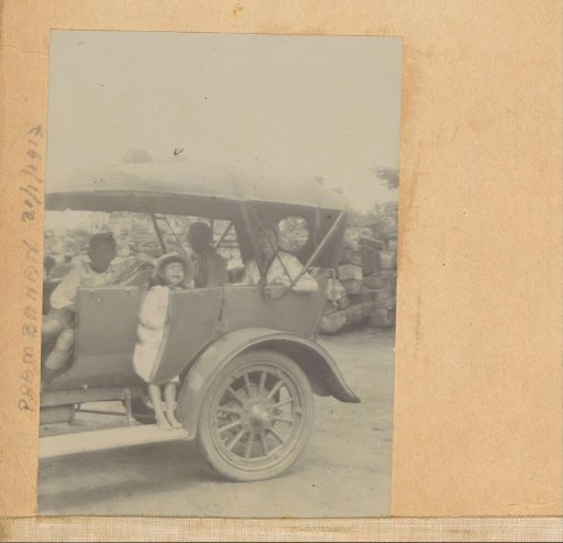 People with a crying child in a carriage in Prambanan
