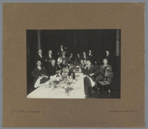 Delft student rowing club Laga around a covered table during a celebration
